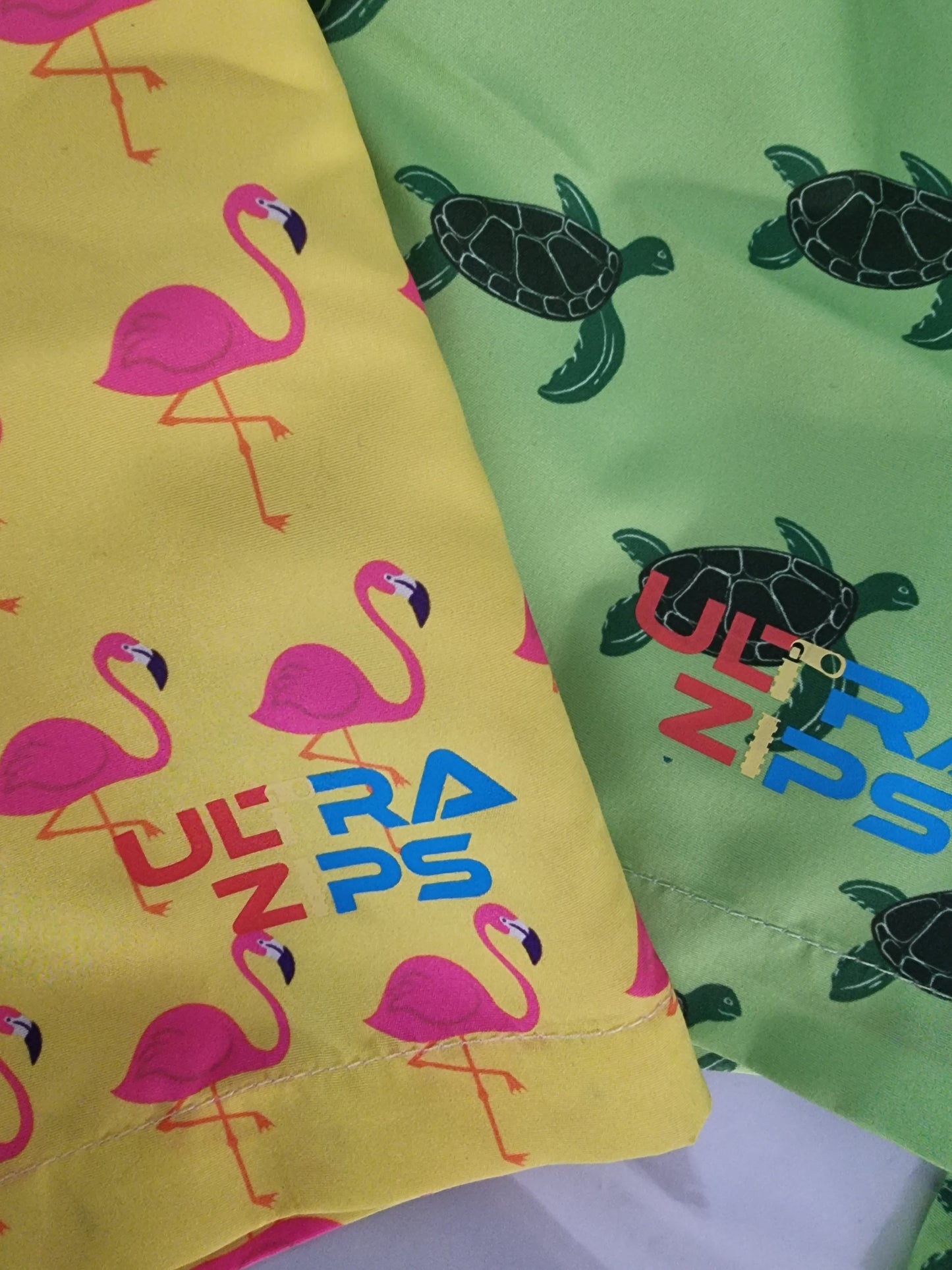 A closeup of the logo on the kids ultra zips boardshorts 